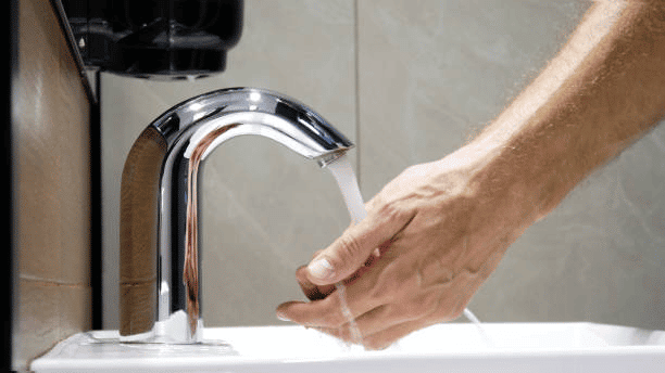 A touchless faucet in use