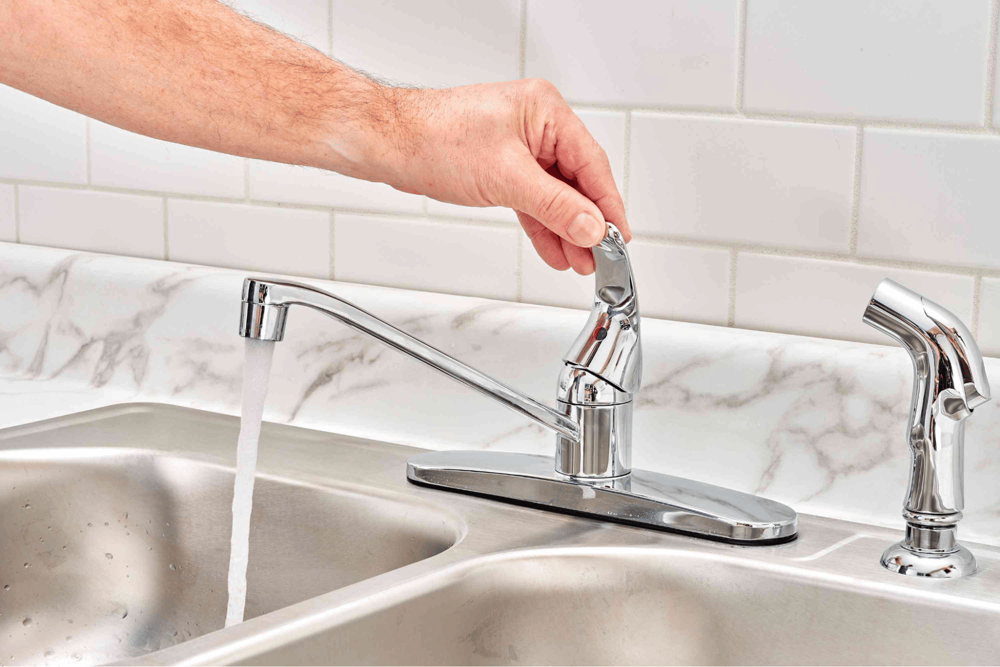 A person utilizing a faucet